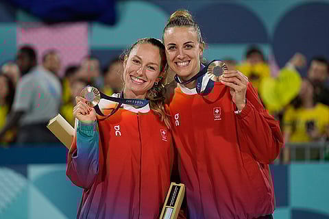 Paris Olympics Women's beach volleyball: Switzerland's Nina Brunner, left, and Tanja Hueberli hold up their bronze medals